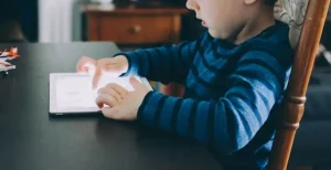 Niño usando una tablet en una app educativa en casa
